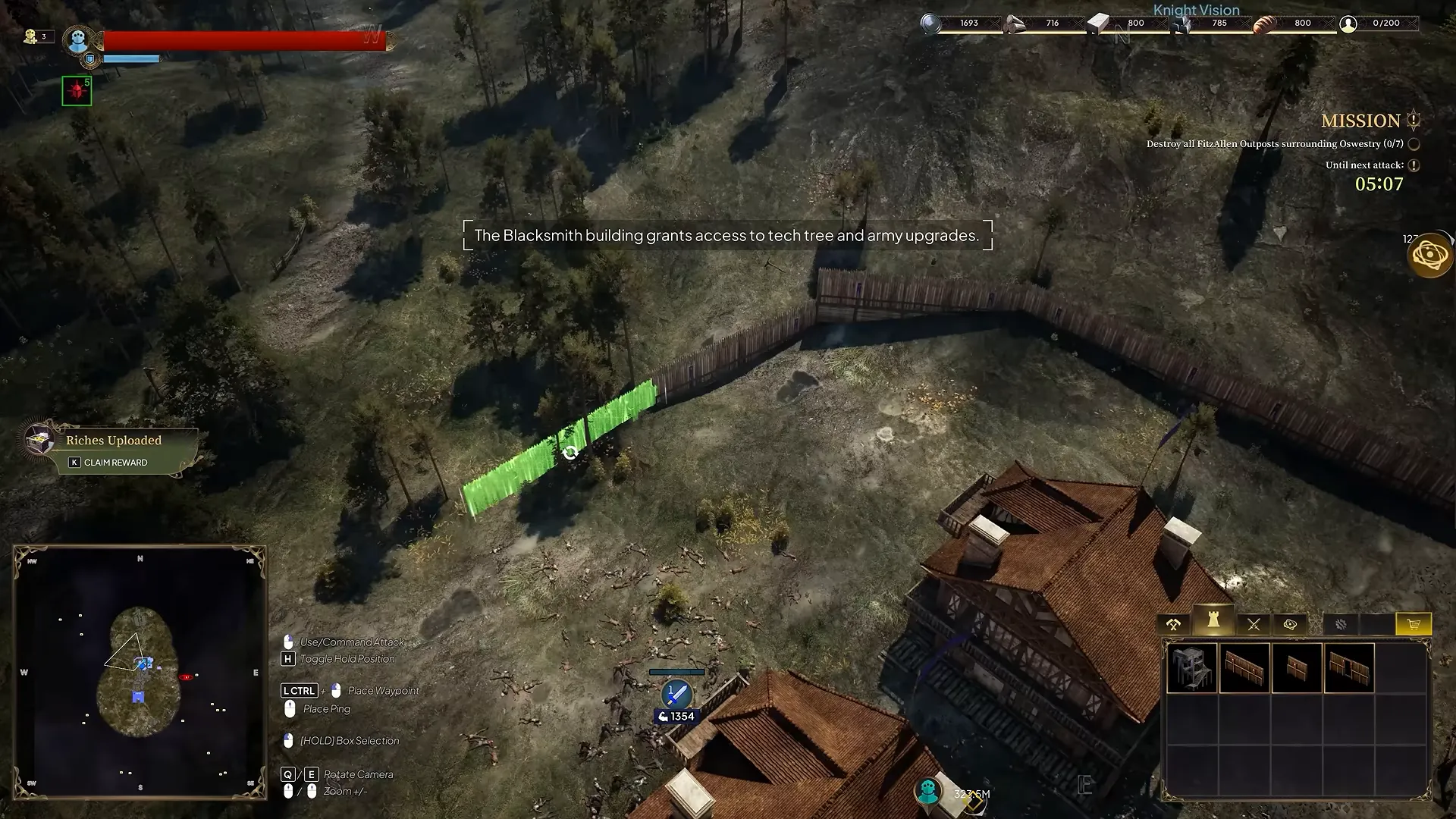 Strategy view with a wall segment highlighted in green while it is being placed near timber buildings.