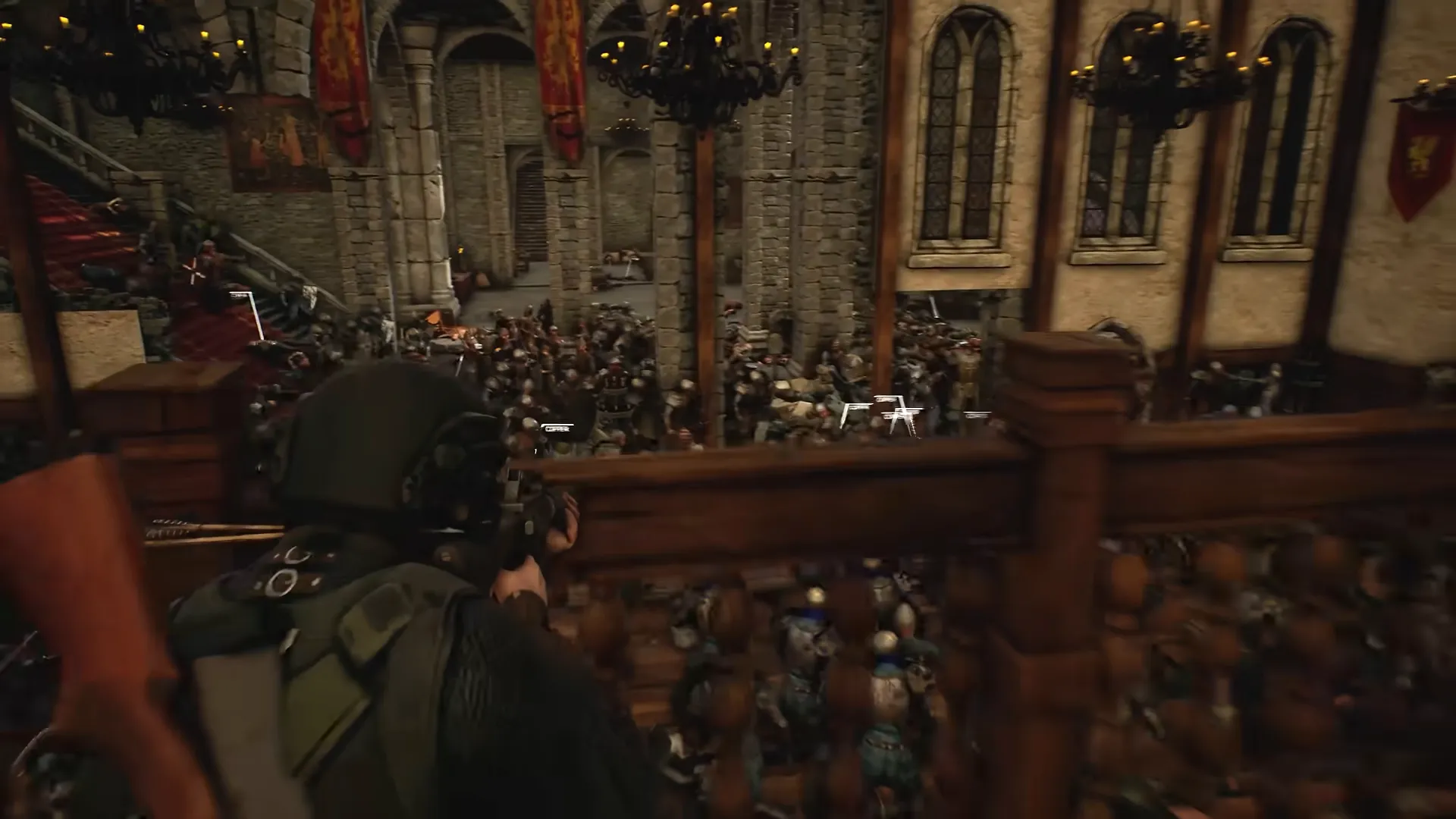 A helmeted soldier on a balcony looks down into a great hall packed with soldiers.